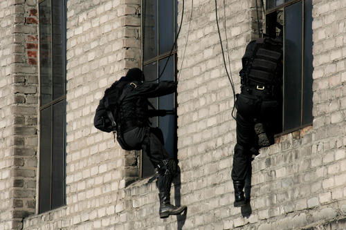 Subdivision anti-terrorist police during a black tactical exercises. Rope Techniques. Real situation.