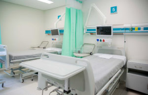 Photo of a hospital room with two beds, both empty