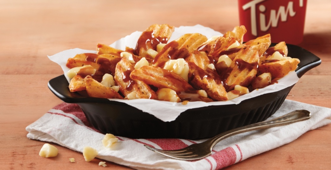 Man eating Tim Hortons poutine hopefully going through a breakup or something