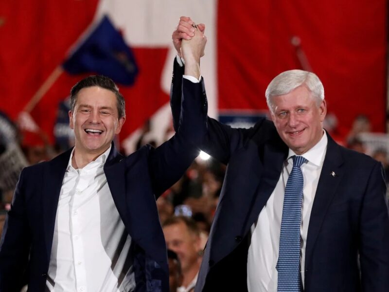 poilievre holding hands up with harper